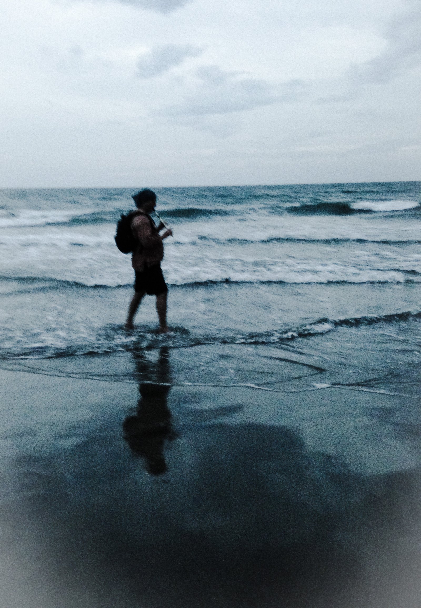 man playing flute in sea